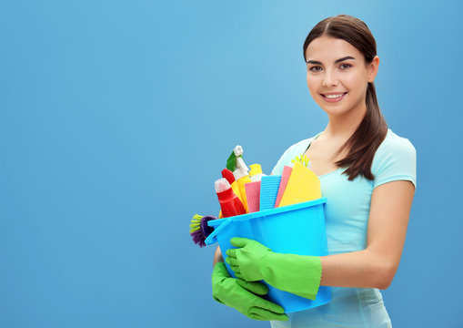 Female cleaner on blue background