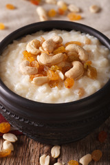 Indian kheer sweet rice pudding with nuts macro. vertical
