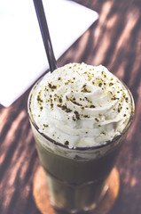 green tea frappe on wood table