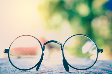 Artwork in retro style, Spectacles and book , vintage styled,selective focus