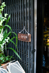 Open sign hanging in front of cafe