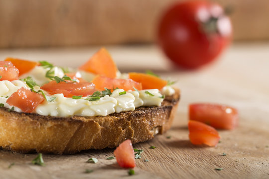 Bruscheta with melted cheese and tomatoes