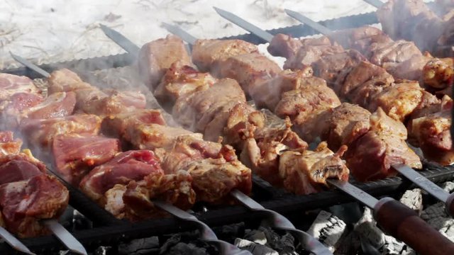 Cooking of pork shashlik on skewers on the grill