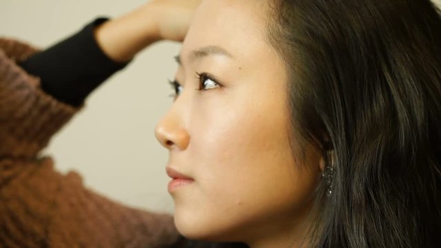Depressed beautiful Asian woman sitting and thinking 