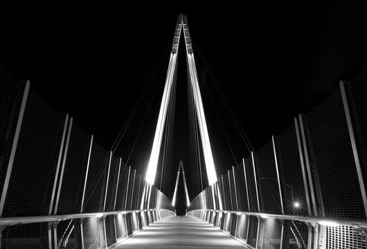 Fototapeta Pedestrian bridge at night. Graphical architectural structure