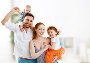 happy family mother, father and children at home