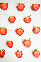 Sliced strawberry on white wooden background with copyspace. Healthy food concept. Fresh summer background.