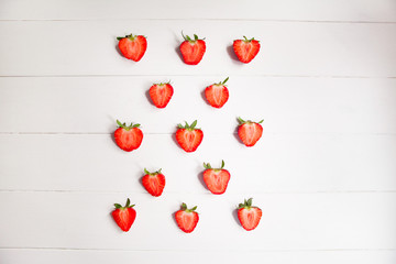 Sliced strawberry on white wooden background with copyspace. Healthy food concept. Fresh summer background.