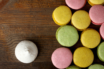 macaroon with cookies on wooden brown background