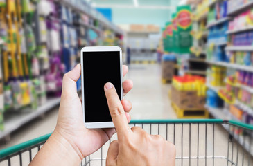 Hand press on big blank smartphone screen or mobile phone on shopping mall or supermarket