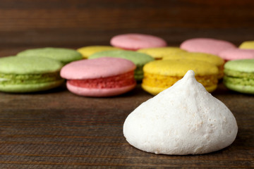 macaroon with cookies on wooden brown background