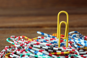 one clip stands out from the pile of paper clips. The concept of individuality