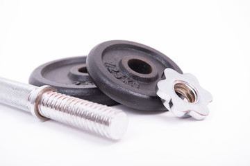 Parts of a disassembled black dumbbell