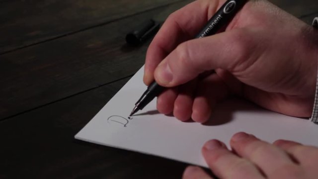 Caucasian male hands writing Dear Mr. President on blank sheet of paper closeup