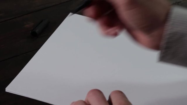 Caucasian male hands writing Dear Mr. President on blank sheet of paper closeup