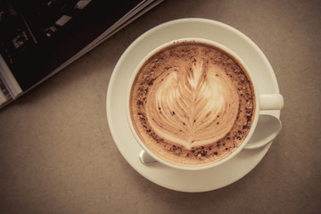Cup of art latte on a cappuccino coffee