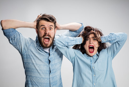 Close Up Photo Of Angry Man And Woman Touching Their Heads