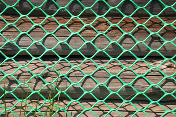 A fragment of a wooden wall with a grid
