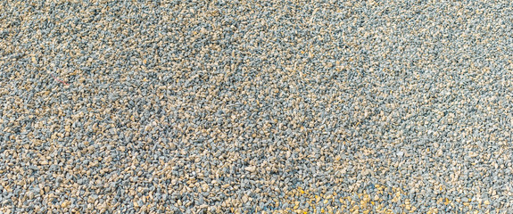 Small colored stone gravel covered surface fragment as abstract background texture.