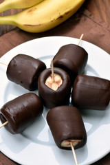 Frozen banana covered with chocolate