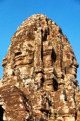 Stone carved face of Bayon Temple in Angkor Thom, Angkor district, Siem Reap, Cambodia. Close up