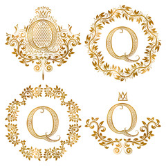 Golden Q letter vintage monograms set. Heraldic coats of arms and round frames.