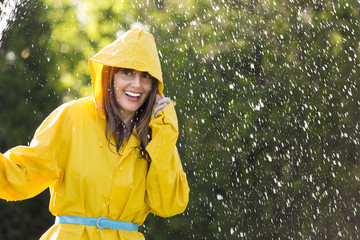 Woman in yellow raincoat  out in the rain