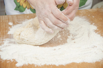 Women's hands preparing fresh yeast dough