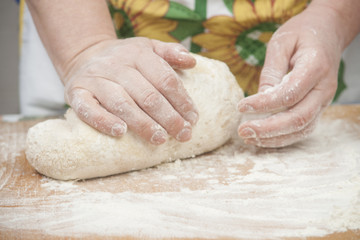 Women's hands preparing fresh yeast dough