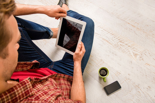 Close Up Photo Of Young Man Holding Tablet