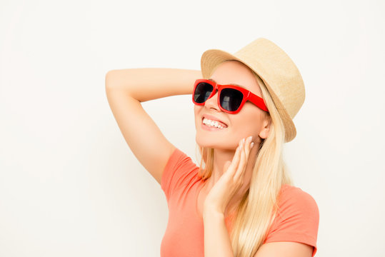 Portrait of positive young woman in summer hat and spectacles
