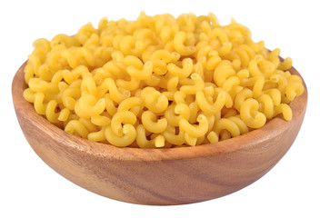 Uncooked italian pasta in a wooden bowl on a white