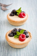 Delicious tartlets with raspberries and blueberries
