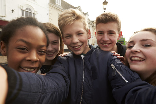 Teenagers Taking Selfie On Mobile Phone In Urban Setting