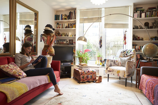 Woman Relaxing With Digital Tablet In Stylish Apartment