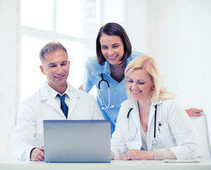 group of doctors looking at tablet pc