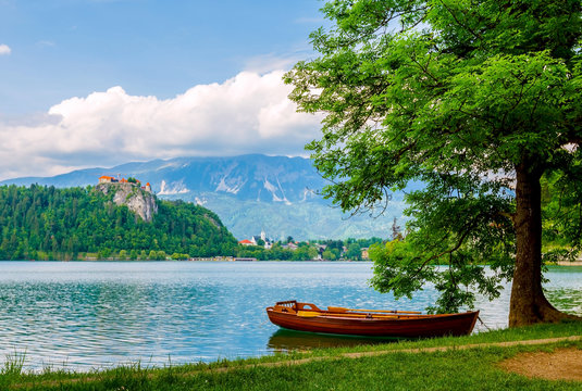 Boat on the lake with view of castle on cliff at Bled, Slovenia