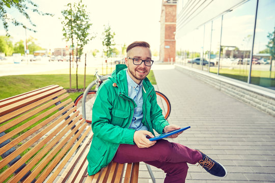 happy young hipster man with tablet pc and bike
