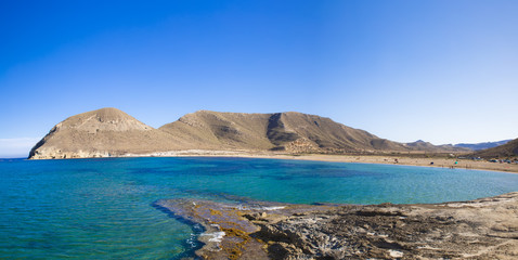 Beautiful view on bright blue bay against of mountain, in Playazo de Rodalquilar, Cabo de Gata, Nijar, Spain