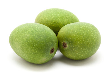 Three Organic green Indian Mangoes (Mangifera indica) isolated on white background. Front view.