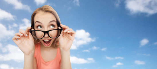 happy young woman or teenage girl in eyeglasses