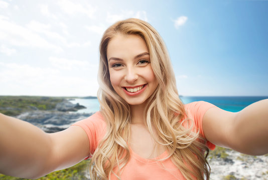 happy smiling young woman taking selfie