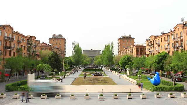 The background of the boulevard with trees, statues, people.Cascade of Armenia, timelapse footage