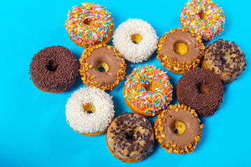 Fototapeta na wymiar Assorted donuts on a blue background