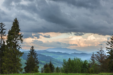 Storm clouds over mountains and the forest