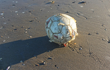 vecchia palla da calcio su sfondo sabbioso