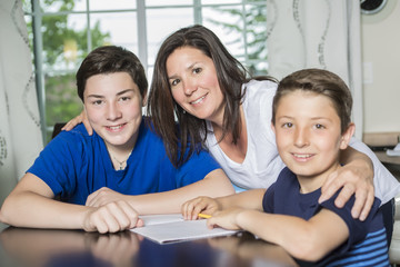 Mother Helping Son With Homework At Table