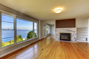 Living room interior with hardwood floor, fireplace and water vi