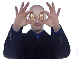 man holding two golden eggs