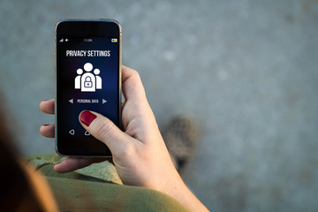 Woman walking smartphone privacy settings